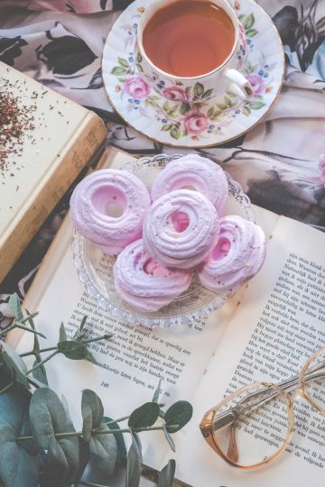 floral ceramic cup and saucer above open book