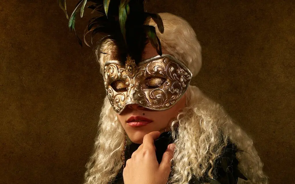 alluring woman in carnival mask and eyes closed